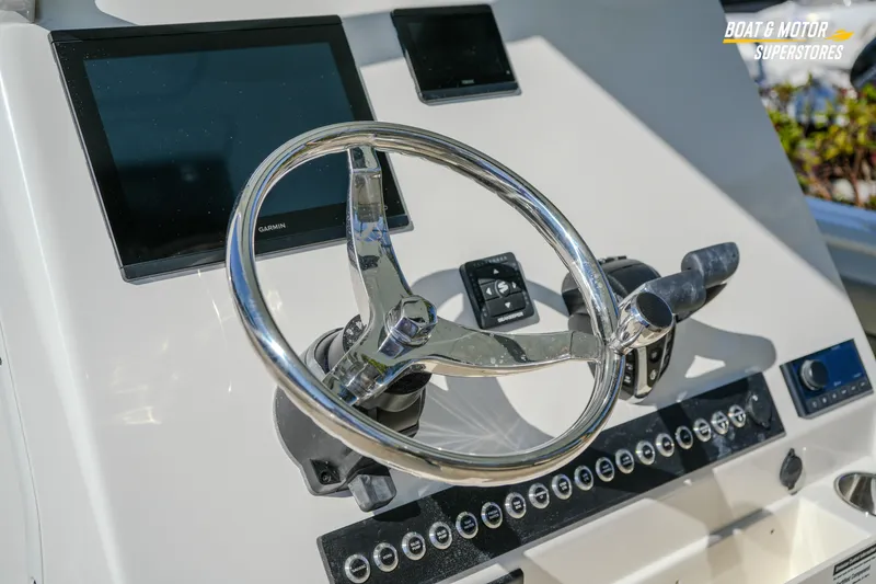 Slide: The Image of 2026 Key West 260 Center Console boat helm with Garmin displays and controls. - 49