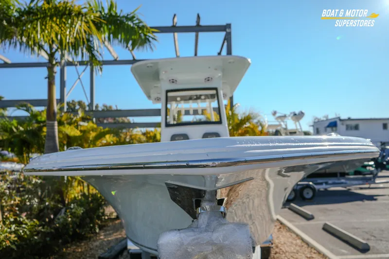 Slide: The Image of 2026 Key West 260 Center Console boat displayed outdoors with palm trees. - 5