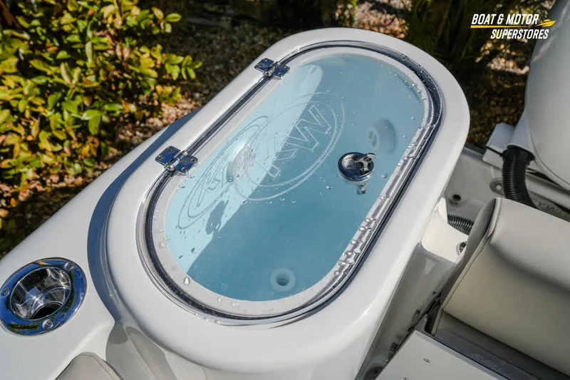 Slide: The Image of 2026 Key West 260 Center Console boat livewell with water droplets, outdoor setting. - 51