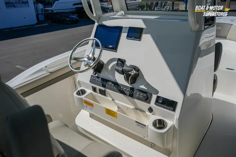 Slide: The Image of 2026 Key West 260 Center Console boat dashboard with steering wheel and controls. - 52