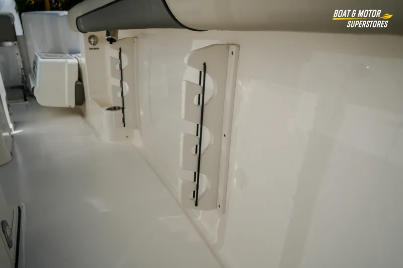 Slide: The Image of 2026 Key West 260 Center Console boat interior with rod holders and storage. - 58
