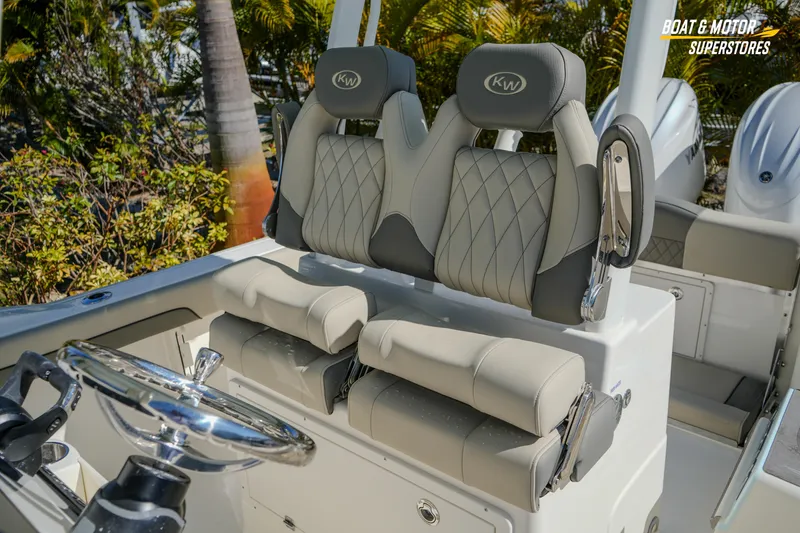 Slide: The Image of 2026 Key West 260 Center Console boat with luxurious seating and steering wheel. - 61
