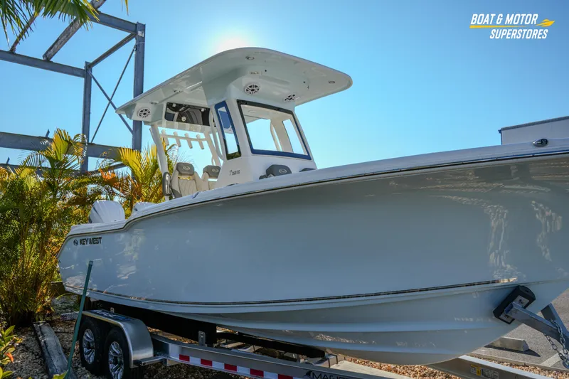 Slide: The Image of 2026 Key West 260 Center Console boat on trailer, sunny day, palm trees in background. - 7