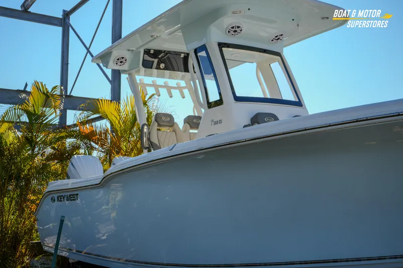 Slide: The Image of 2026 Key West 260 Center Console boat displayed outdoors with tropical plants. - 8