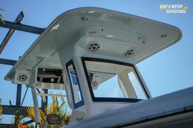 Slide: The Image of 2026 Key West 260 Center Console boat with speakers and canopy, sunny day. - 9