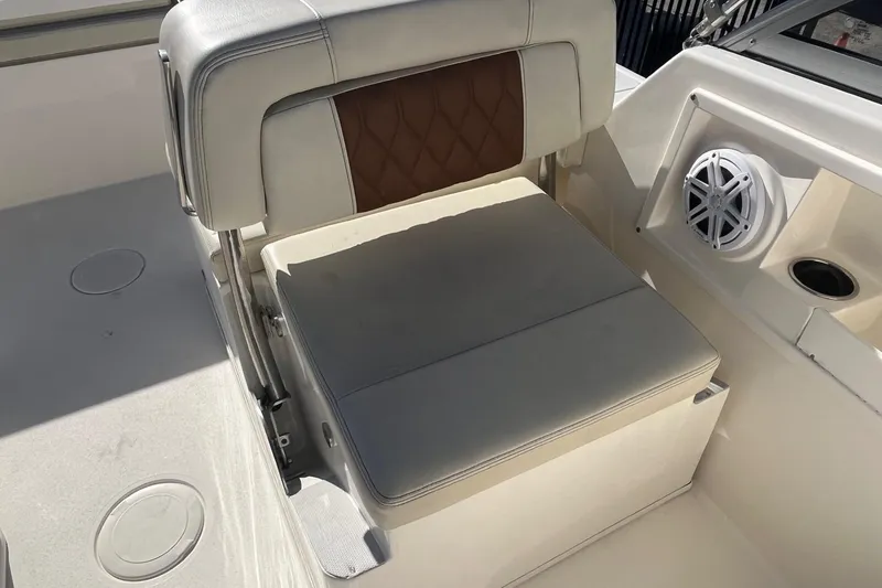 Slide: The Image of 2023 Cobia 220 Dual Console boat seat with speaker and cup holder. - 10