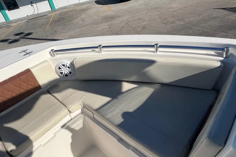 Slide: The Image of 2023 Cobia 220 Dual Console boat interior with cushioned seating and speaker. - 8