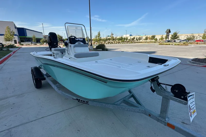 Slide: The Image of 2026 Mako Pro Skiff 15 CC boat on trailer in parking lot. - 11