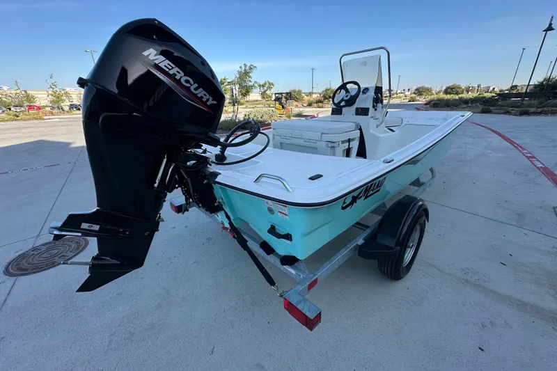 Slide: The Image of 2026 Mako Pro Skiff 15 CC boat with Mercury engine on trailer. - 14