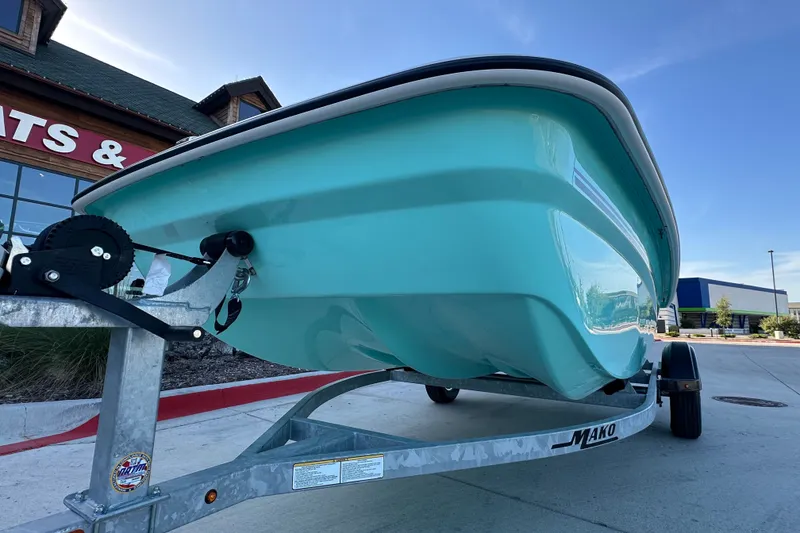 Slide: The Image of 2026 Mako Pro Skiff 15 CC boat on trailer outside dealership. - 9