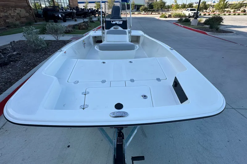 Slide: The Image of 2026 Mako Pro Skiff 15 CC boat displayed outdoors on a trailer. - 10