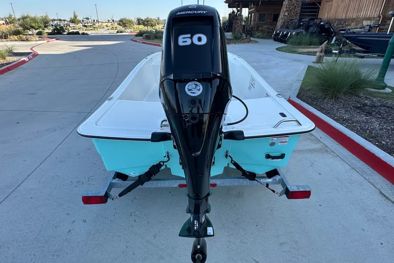 Slide: The Image of 2026 Mako Pro Skiff 15 CC with Mercury 60 engine on trailer. - 15