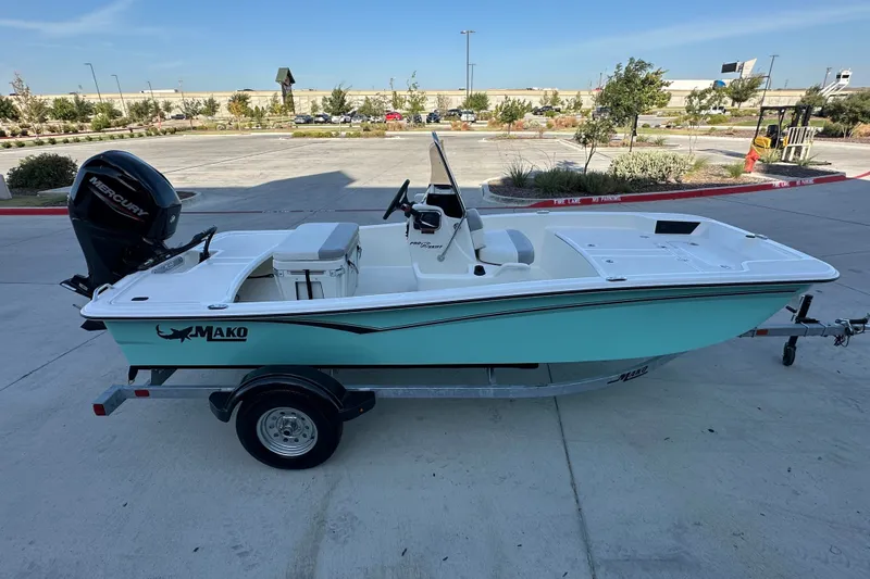 Slide: The Image of 2026 Mako Pro Skiff 15 CC boat on trailer, parked outdoors. - 12