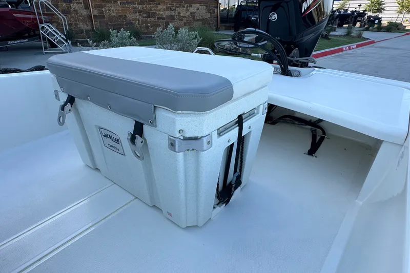Slide: The Image of 2026 Mako Pro Skiff 15 CC boat interior with cushioned storage seat. - 19