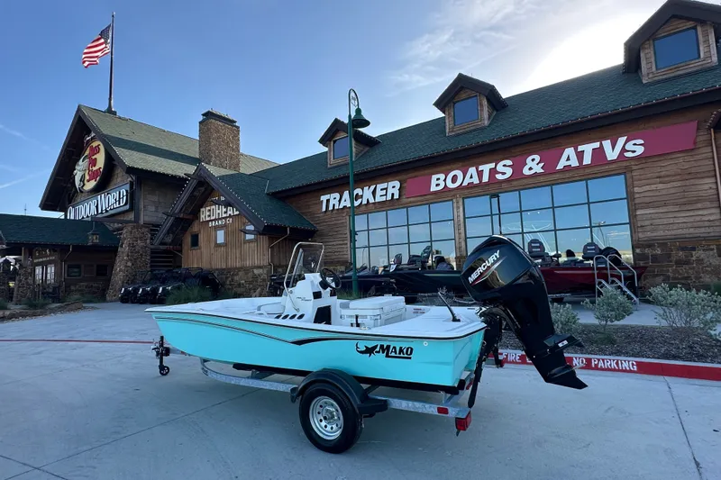 The Image of 2026 Mako Pro Skiff 15 CC boat displayed outside a Tracker Boats & ATVs store. - 6