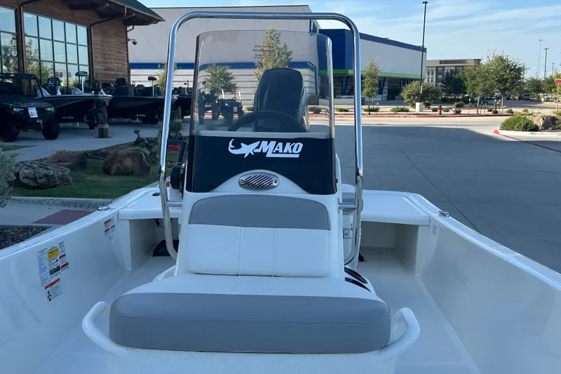 Slide: The Image of 2026 Mako Pro Skiff 15 CC boat with center console in outdoor showroom. - 22
