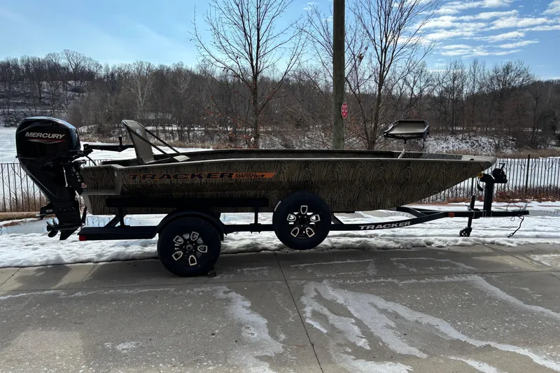 The Image of 2026 Tracker Grizzly 1756 T Marsh boat on trailer, snowy outdoor setting. - 0