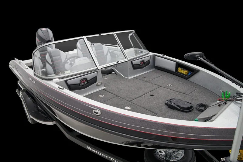 Slide: The Image of 2026 Ranger 1880MS boat interior with green accents and carpeted flooring. - 14