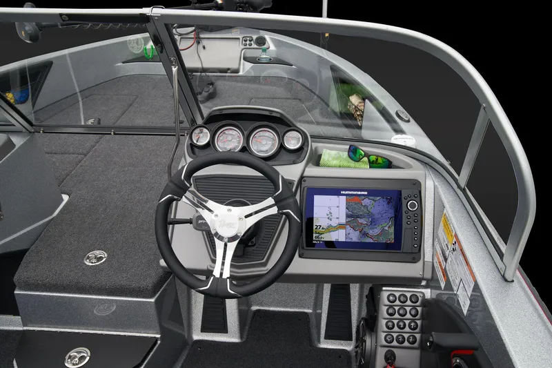 Slide: The Image of 2026 Ranger 1880MS boat interior with green accents and storage compartment. - 33