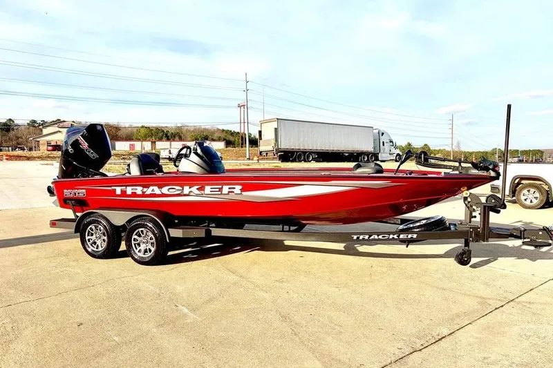 The Image of 2026 Tracker Savage 215 boat in vibrant red on a trailer, parked outdoors. - 0