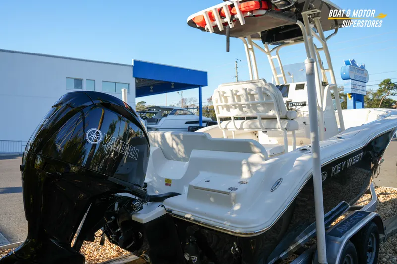 Slide: The Image of 2023 Key West 219 FS boat with Yamaha engine at dealership display. - 11