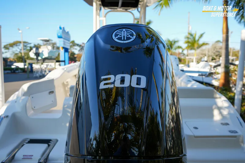 Slide: The Image of 2023 Key West 219 FS boat with Yamaha 200 outboard motor, displayed outdoors. - 14