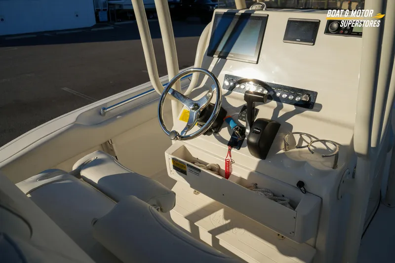 Slide: The Image of 2023 Key West 219 FS boat console with steering wheel and controls. - 20