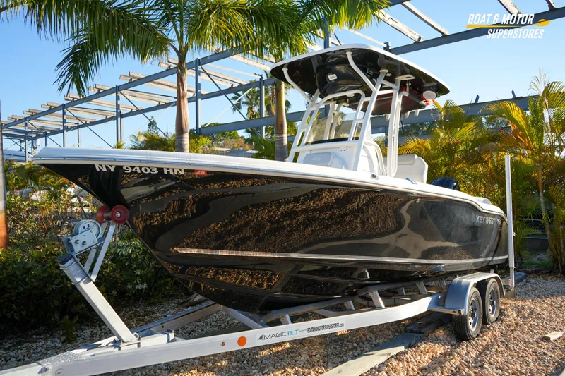 Slide: The Image of 2023 Key West 219 FS boat on trailer, surrounded by palm trees. - 3
