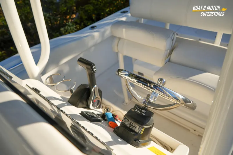 Slide: The Image of 2023 Key West 219 FS boat interior with steering wheel and controls. - 30