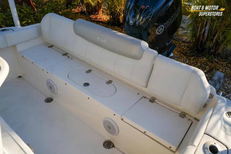 Slide: The Image of 2023 Key West 219 FS boat interior with Yamaha motor, featuring white seating and storage compartments. - 32