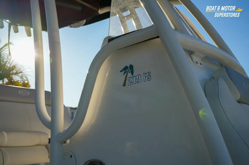 Slide: The Image of 2023 Key West 219 FS boat detail with sunlight and logo. - 7