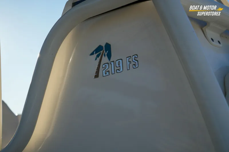 Slide: The Image of 2023 Key West 219 FS boat logo on white surface, sunlight background. - 8