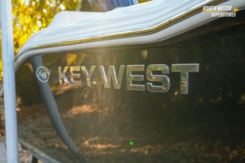 Slide: The Image of 2023 Key West 219 FS boat with reflective logo in sunlight. - 9