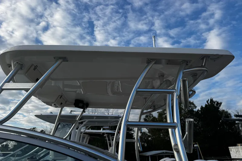 Slide: The Image of 2016 Robalo R247 Dual Console boat with T-top against a cloudy sky. - 13
