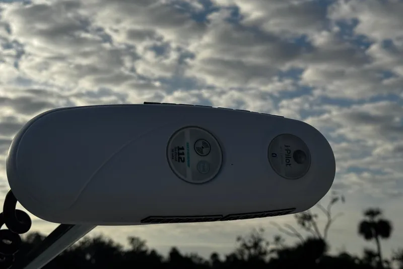 Slide: The Image of Close-up of a 2016 Robalo R247 Dual Console boat control panel against a cloudy sky. - 4