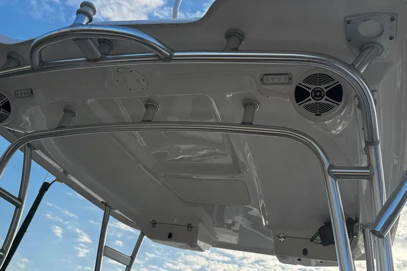 Slide: The Image of 2016 Robalo R247 Dual Console boat top with speakers and metal framework. - 8