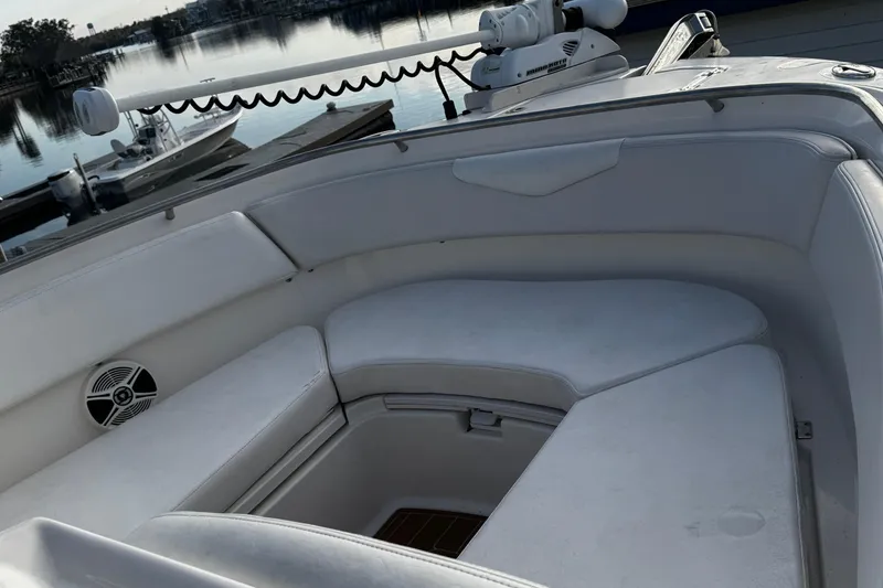 Slide: The Image of 2016 Robalo R247 Dual Console boat interior with white seating and waterfront view. - 9
