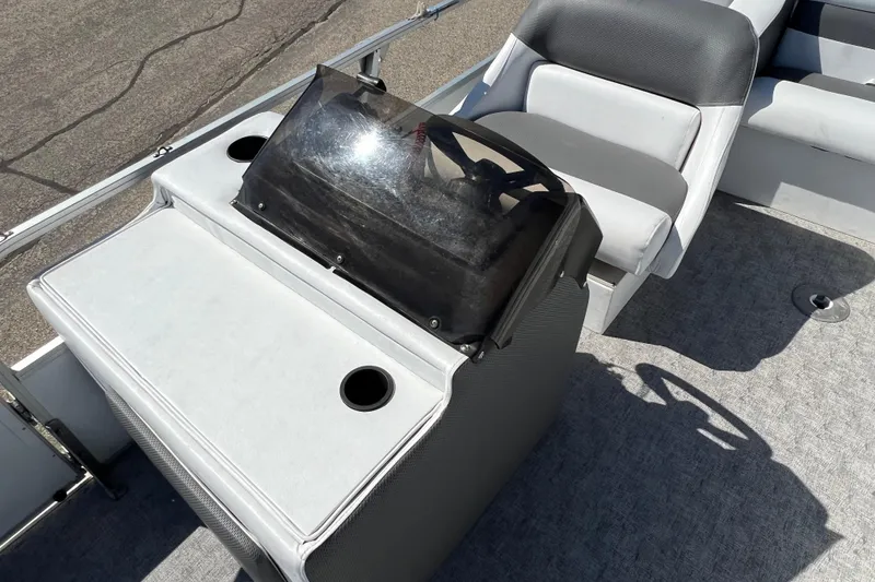 Slide: The Image of 1992 Northwoods Fun Deluxe Pontoon boat interior with steering console and seating. - 11