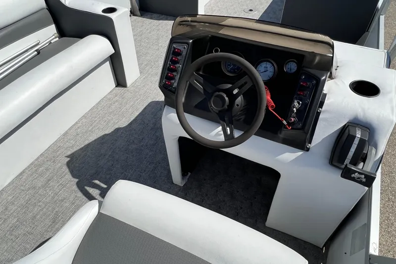 Slide: The Image of 1992 Northwoods Fun Deluxe Pontoon boat interior with steering wheel and dashboard controls. - 13