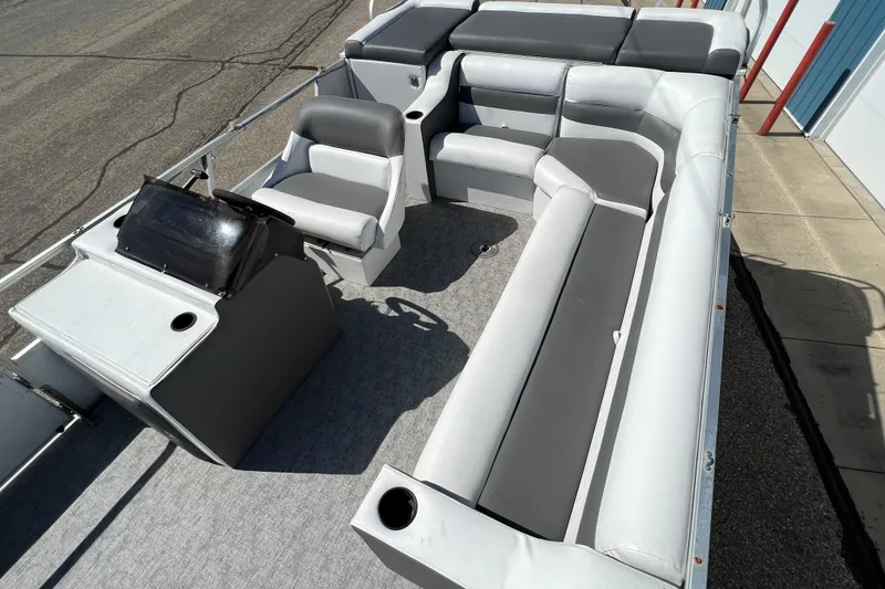 Slide: The Image of 1992 Northwoods Fun Deluxe Pontoon with gray seating and steering console. - 15