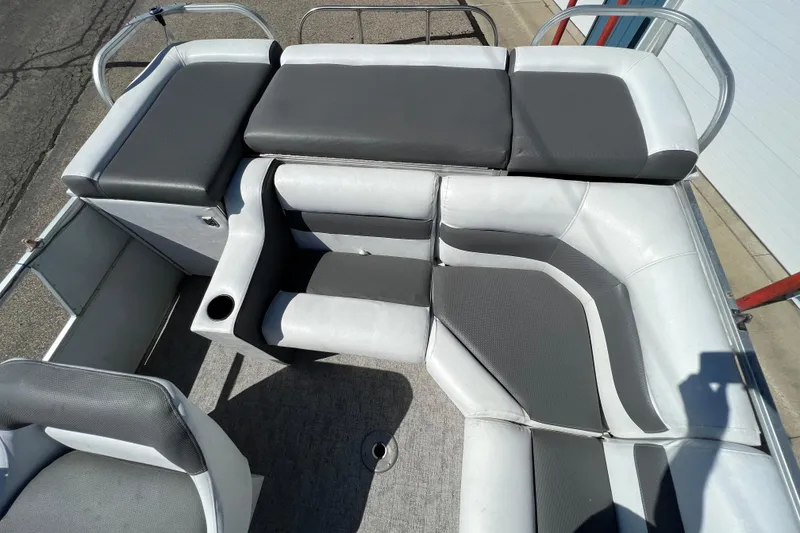 Slide: The Image of 1992 Northwoods Fun Deluxe Pontoon with gray cushioned seating and cup holder. - 17