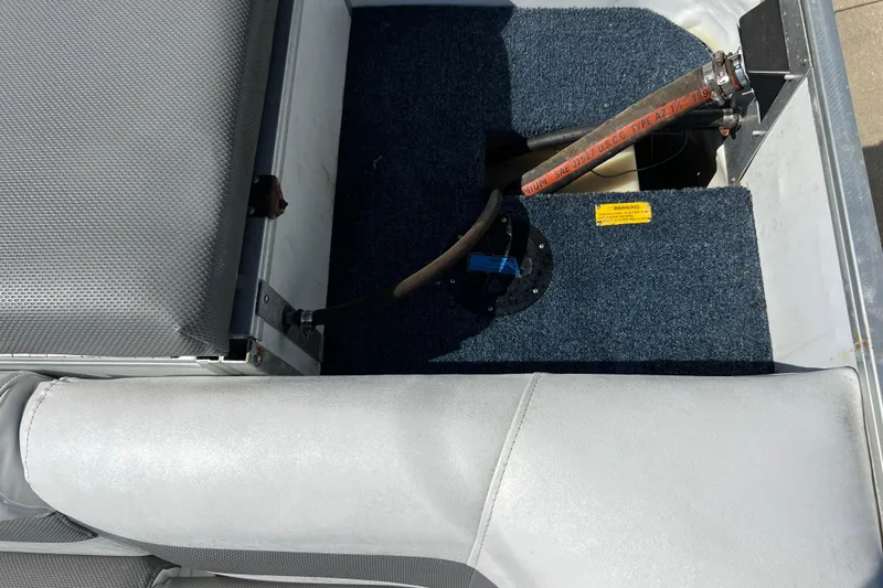 Slide: The Image of Interior view of a 1992 Northwoods Fun Deluxe Pontoon, showing seating and carpeted flooring. - 20