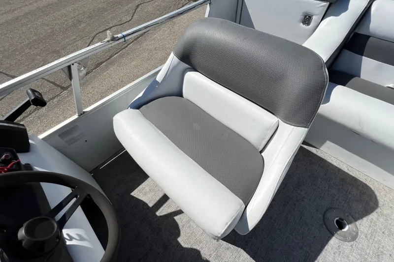 Slide: The Image of 1992 Northwoods Fun Deluxe Pontoon seat with gray upholstery and steering wheel. - 21