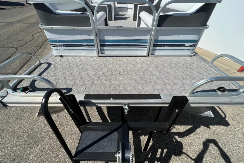 Slide: The Image of 1992 Northwoods Fun Deluxe Pontoon with carpeted deck and seating, viewed from rear. - 3