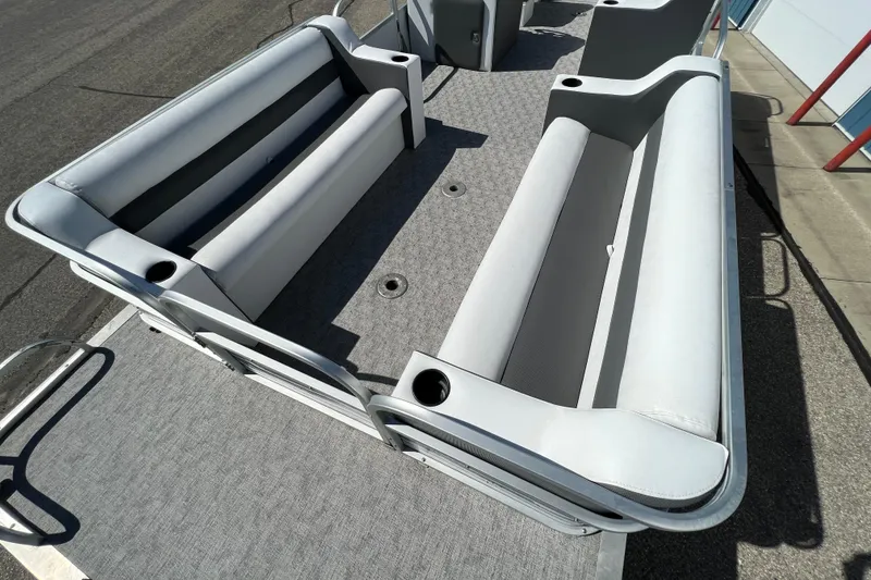 Slide: The Image of 1992 Northwoods Fun Deluxe Pontoon with gray seating and cup holders on deck. - 4