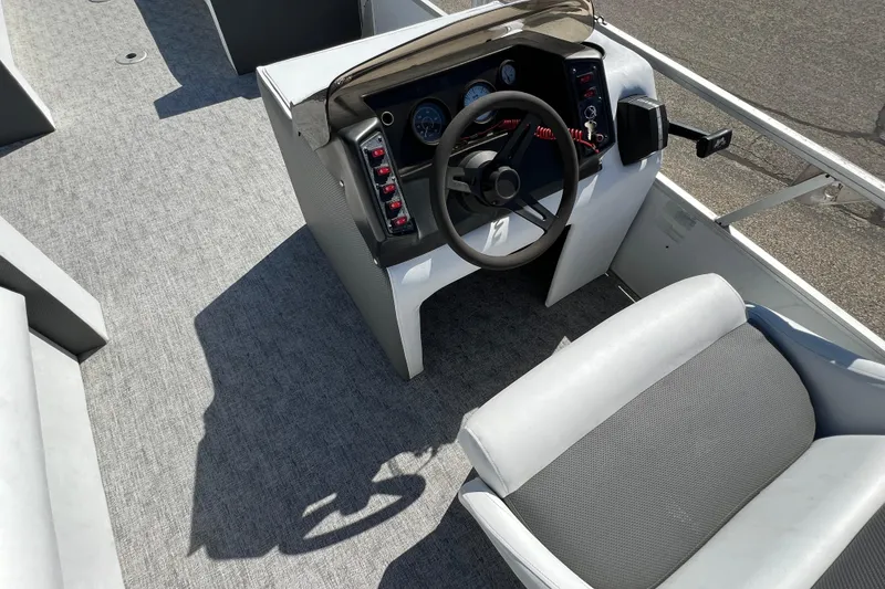 Slide: The Image of 1992 Northwoods Fun Deluxe Pontoon boat interior with steering wheel and seating. - 6