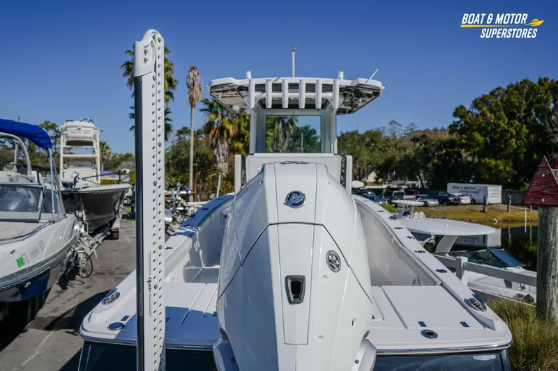 Slide: The Image of 2025 Blackfin 262 HB boat displayed at a dealership with clear blue sky. - 14