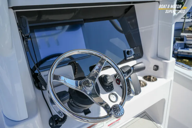 Slide: The Image of 2025 Blackfin 262 HB boat helm with steering wheel and navigation controls. - 21