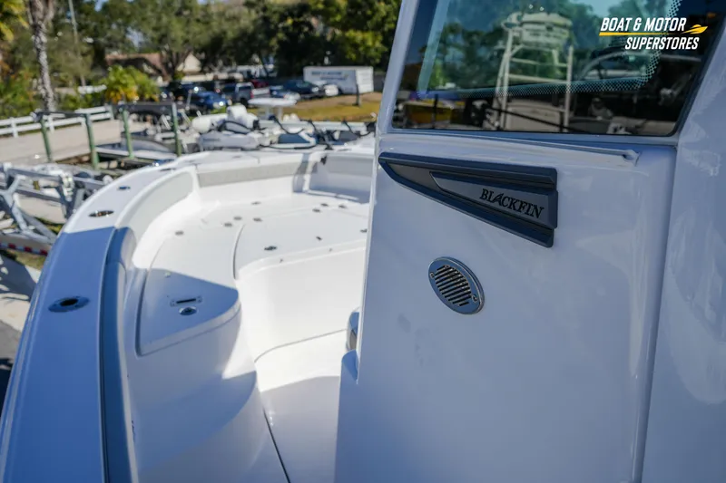 Slide: The Image of 2025 Blackfin 262 HB boat at dealership, showcasing sleek design and spacious deck. - 23