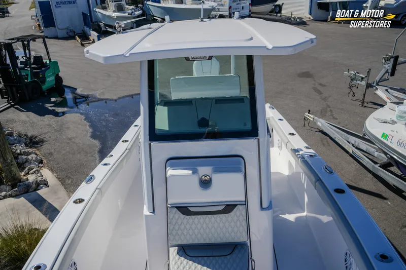 Slide: The Image of 2025 Blackfin 262 HB boat at dealership, showcasing helm and deck features. - 28